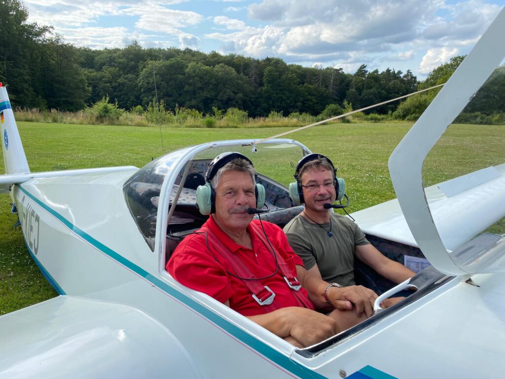 Udo Kesberg (links) zusammen mit Flugschüler Christian Voit im Motorsegler SF 25C (D-KIEJ) nach seiner 15.000sten Landung am 17. Juli 2024.